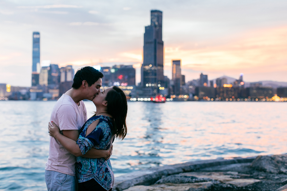 A fiery sunset | Couple kissing with Hong Kong night skyline